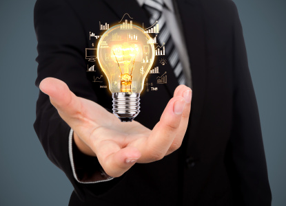 Business man holding light bulb